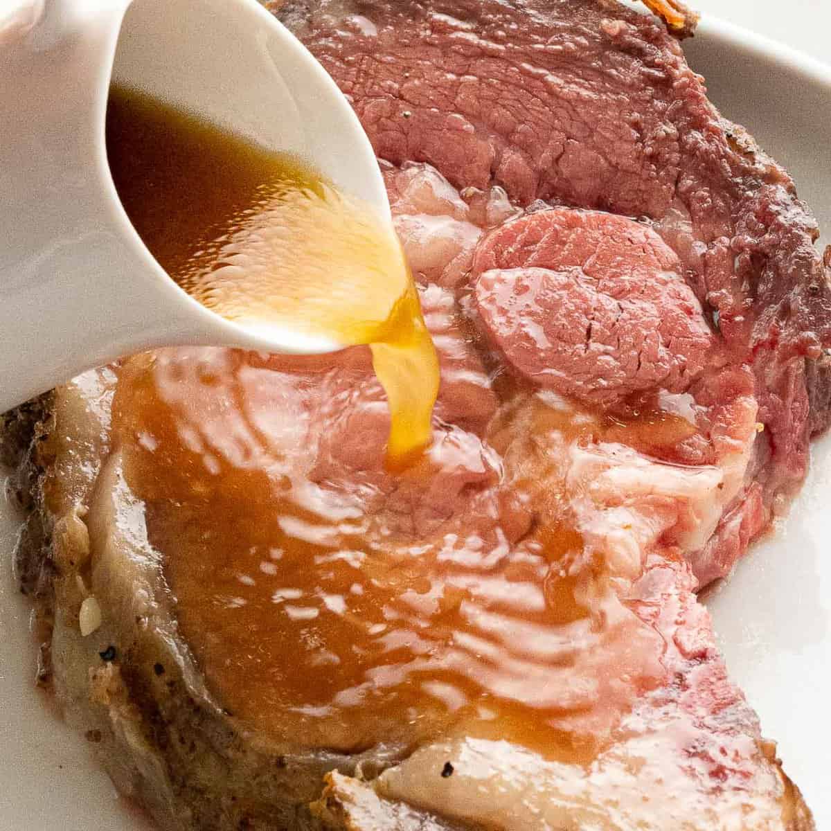 au jus sauce spilling over a big piece of meat